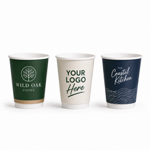 Load image into Gallery viewer, Three custom branded double walled coffee cups: one dark green with white text reading Wild Oak Coffee, one cream with green text reading Your Logo Here, and one dark navy with white text reading The Coastal Kitchen.
