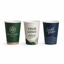 Load image into Gallery viewer, Three customizable paper coffee cups on a white background: one dark green with 'WILD OAK COFFEE', one cream with 'YOUR LOGO Here', and one dark navy with 'The Coastal Kitchen' and wave graphics.
